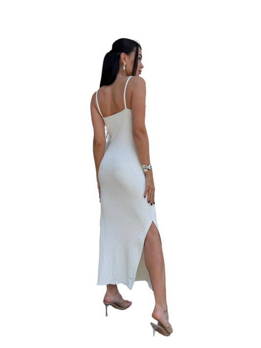 Woman wearing a white dress with a high slit on a white background