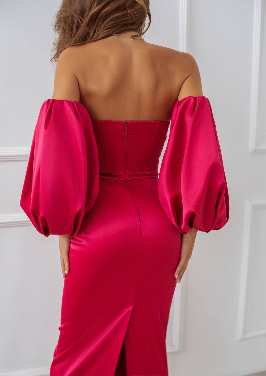 Red jumpsuit with balloon sleeves worn by a person against a white background
