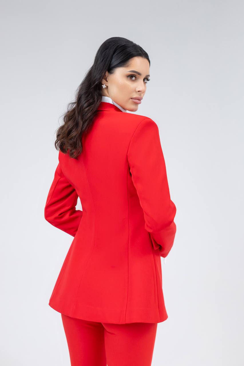 Woman wearing a red suit on a white background
