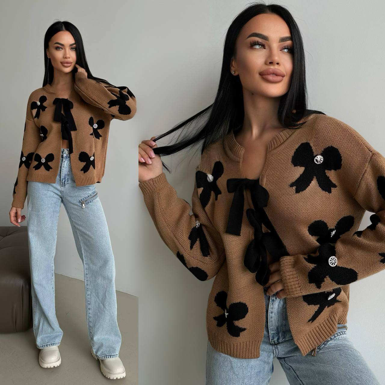 Woman wearing a brown sweater with black floral patterns and light blue jeans.