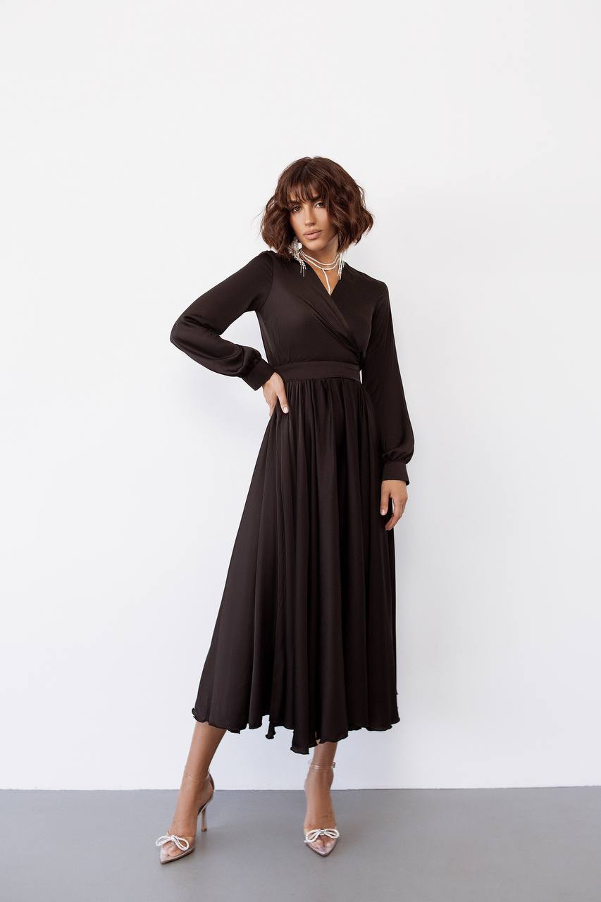 Woman wearing a black dress against a white background
