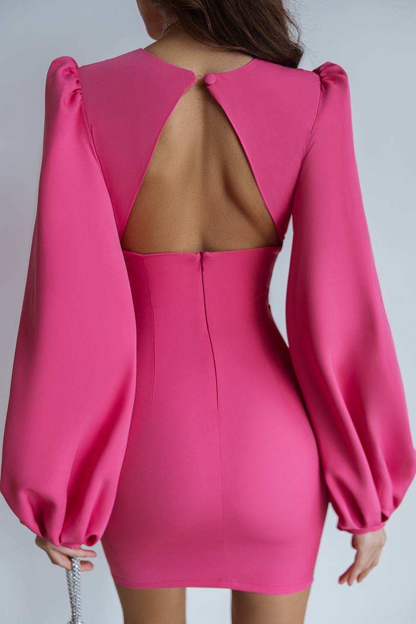 Pink dress with open back and puffed sleeves on a plain background