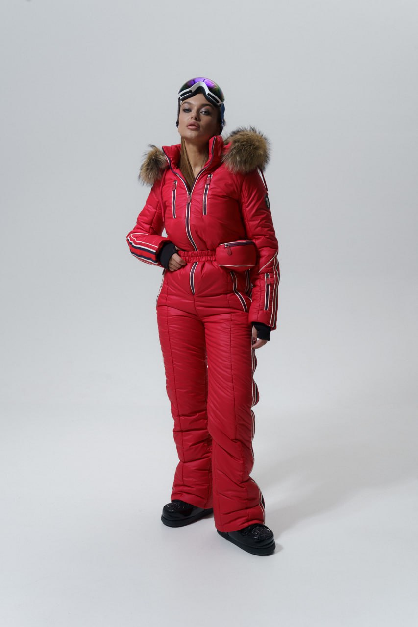 Person wearing a red snowsuit with fur hood on a white background