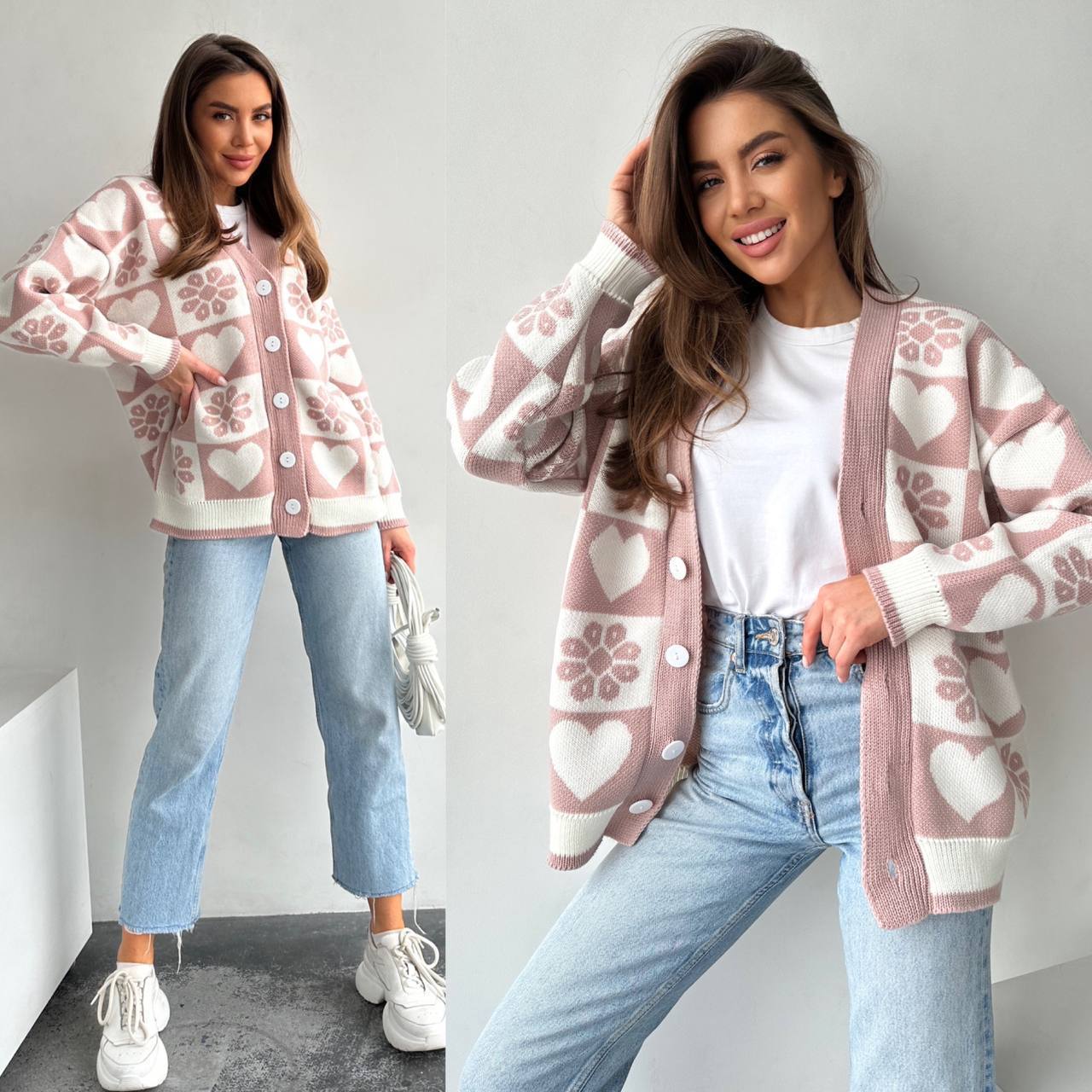 Woman wearing a pink patterned cardigan with light blue jeans and white sneakers.