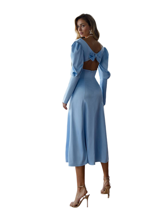 Woman wearing a light blue dress with long sleeves on a white background