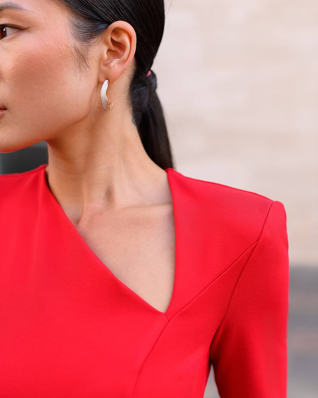 Close-up of a person wearing a red outfit with a blurred background