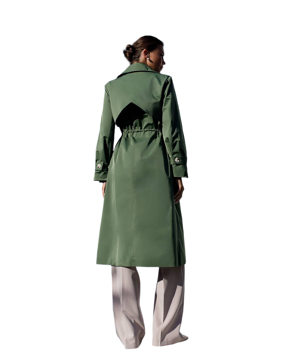 Person wearing a green trench coat on a white background