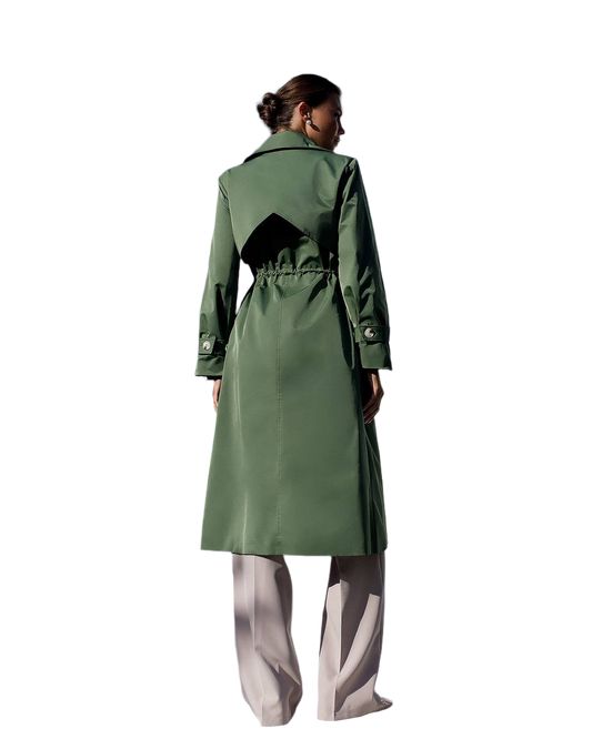 Person wearing a green trench coat on a white background