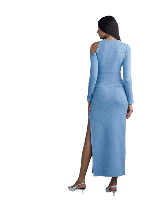 Woman wearing a light blue dress with long sleeves and a high slit on a white background