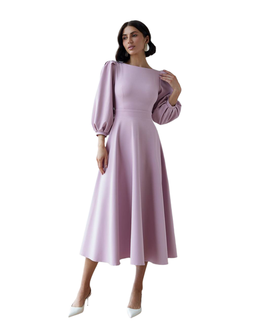 Woman wearing a pink dress with balloon sleeves on a white background