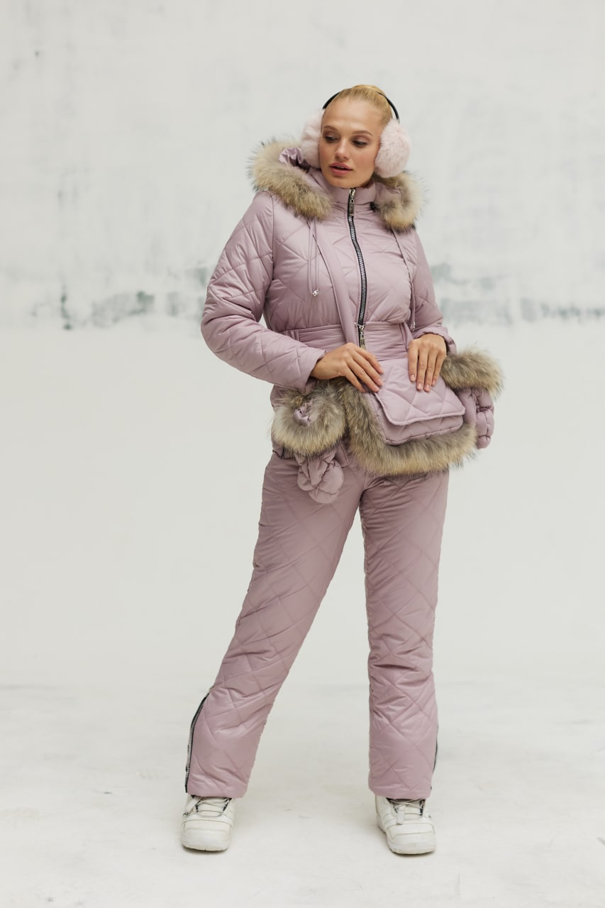Person wearing a pink winter outfit with fur trim on a white background