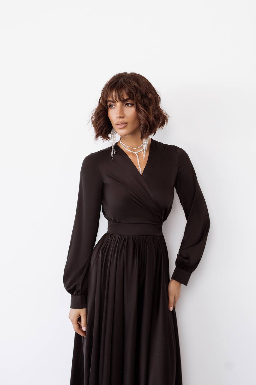 Woman wearing a black dress against a white background