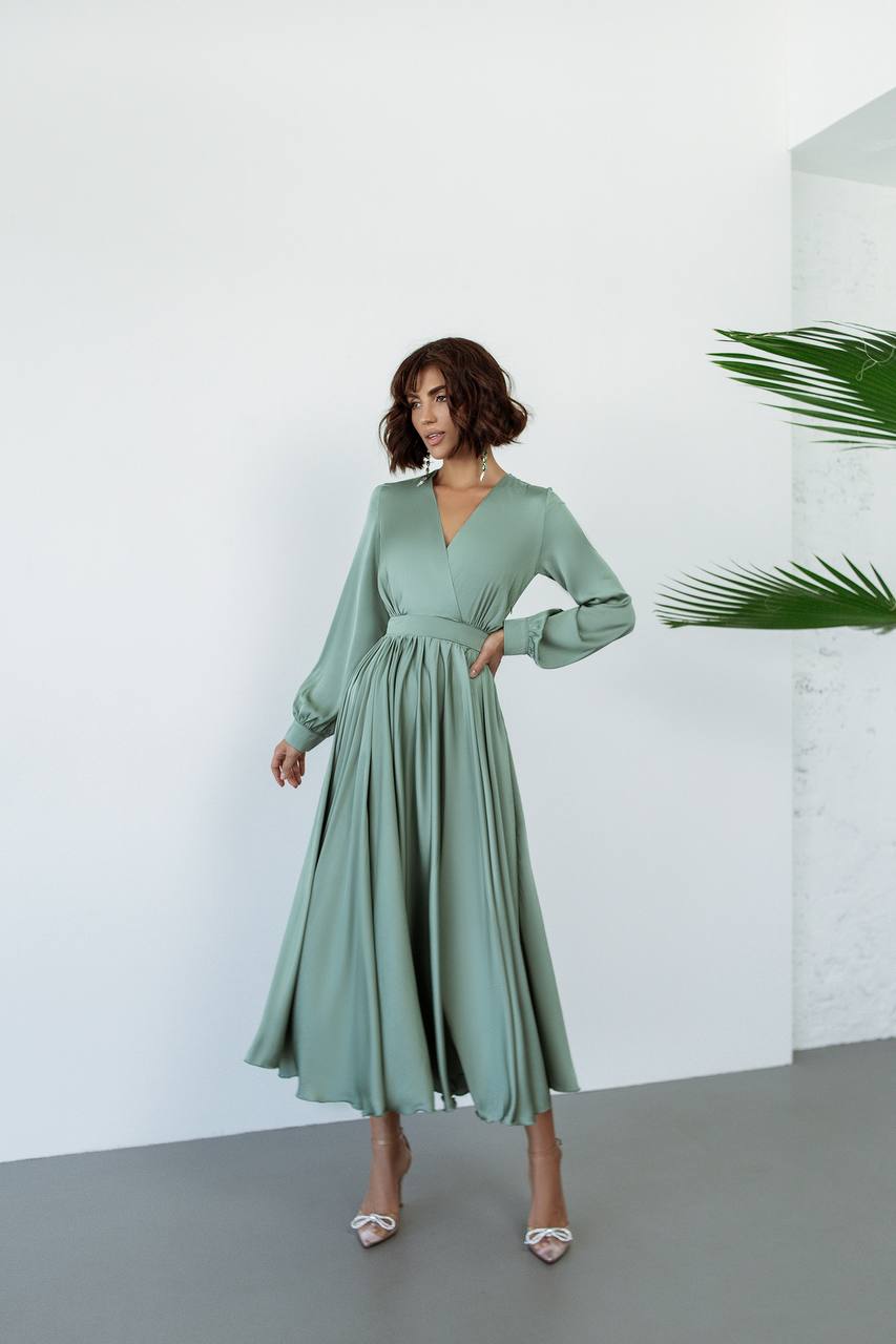 Woman wearing a green dress against a white background