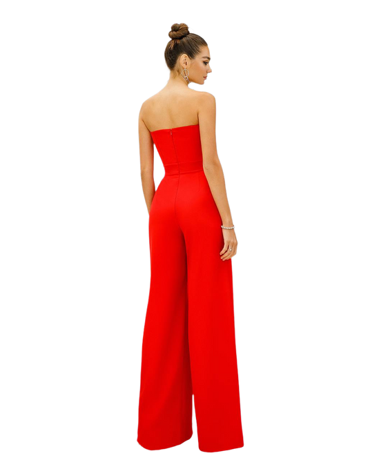 Woman wearing a strapless red jumpsuit on a white background