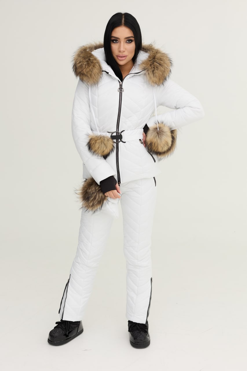 Person wearing a white snowsuit with fur trim on a plain background