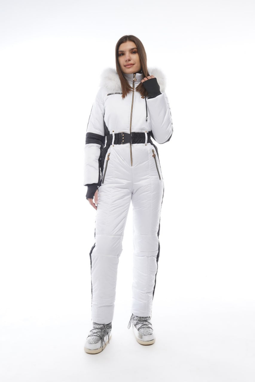 Woman wearing a white ski suit with black accents on a white background