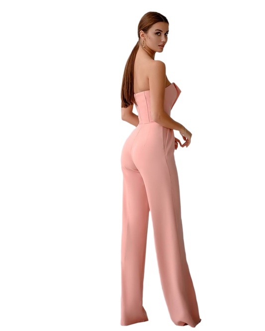 Woman wearing a strapless pink jumpsuit on a white background