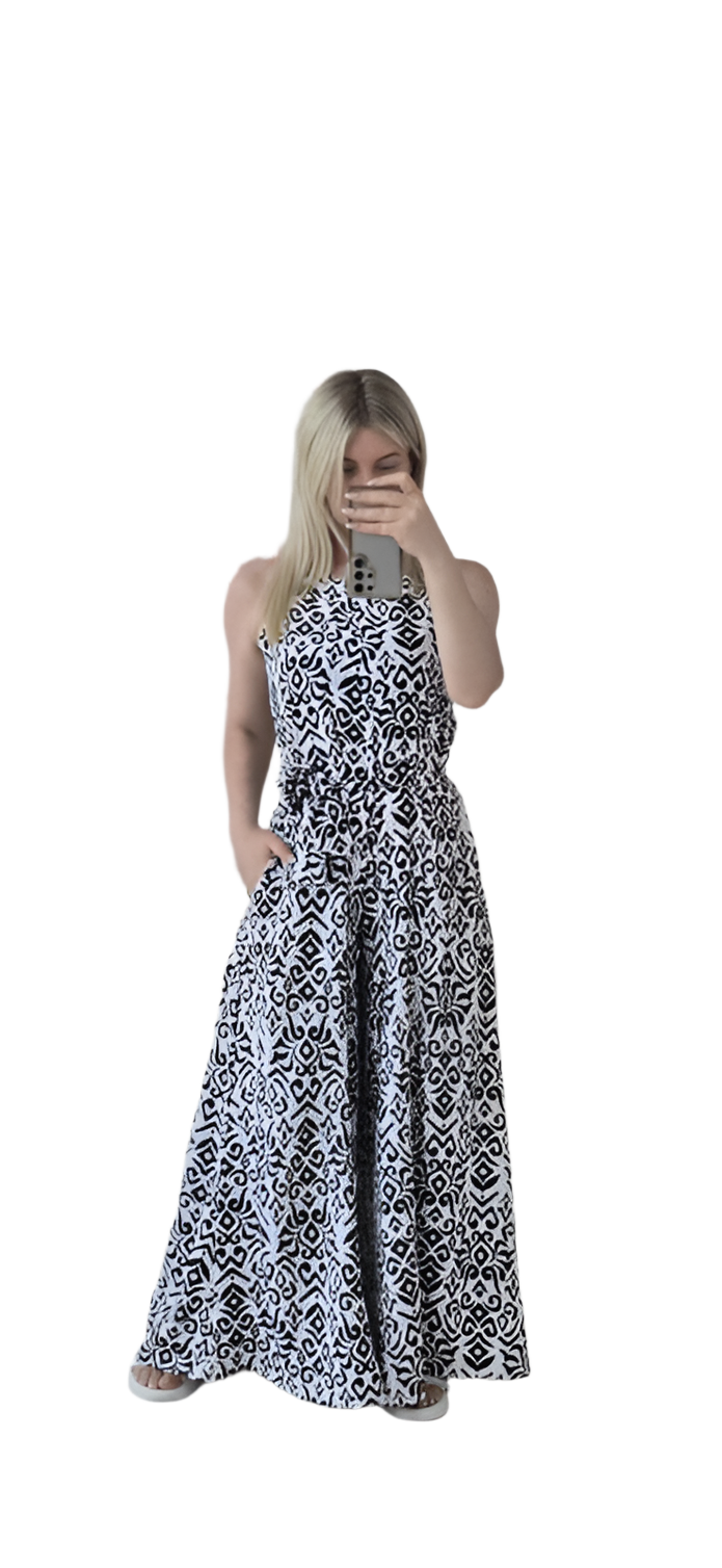 Woman wearing a black and white patterned dress on a white background