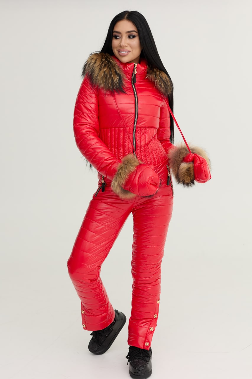 Woman wearing a red puffer suit with fur trim on a white background