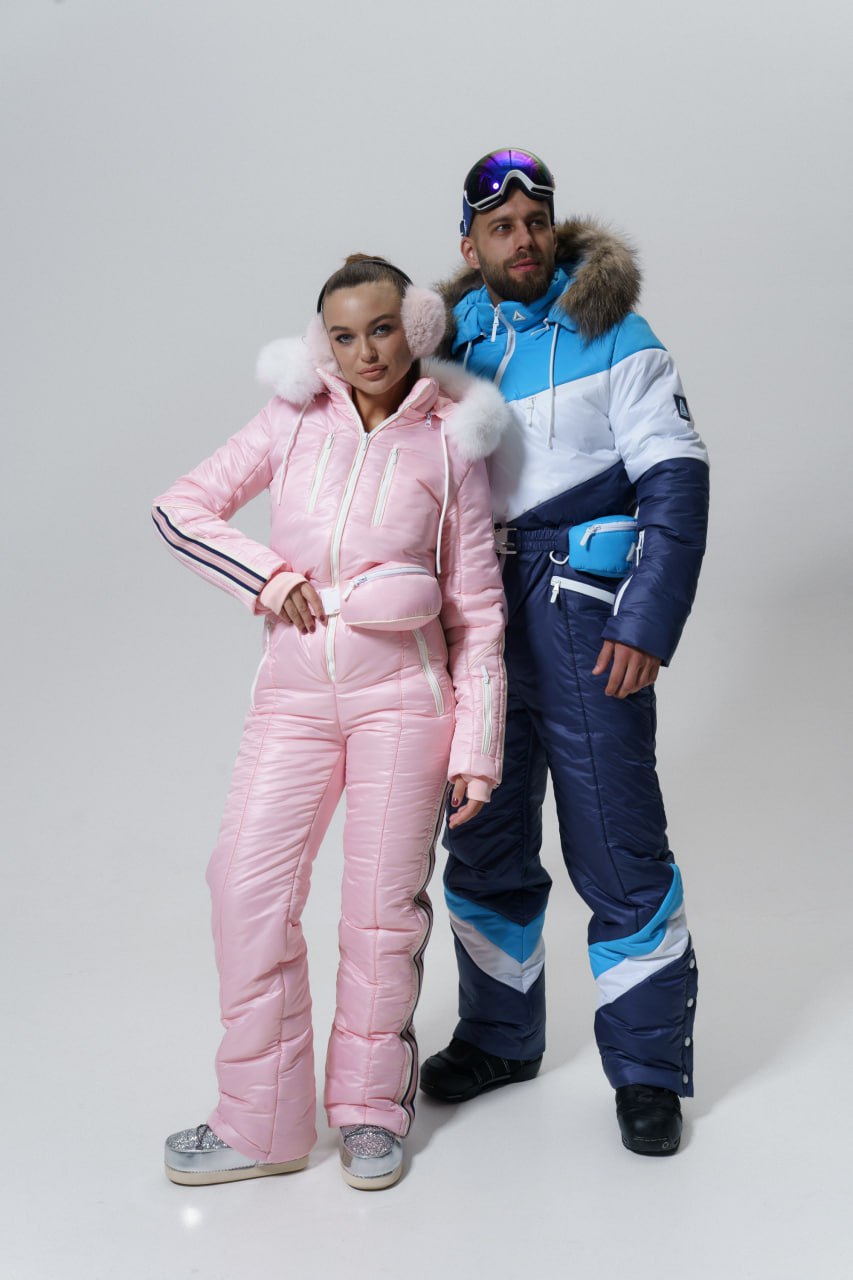 Two people wearing colorful ski suits on a white background