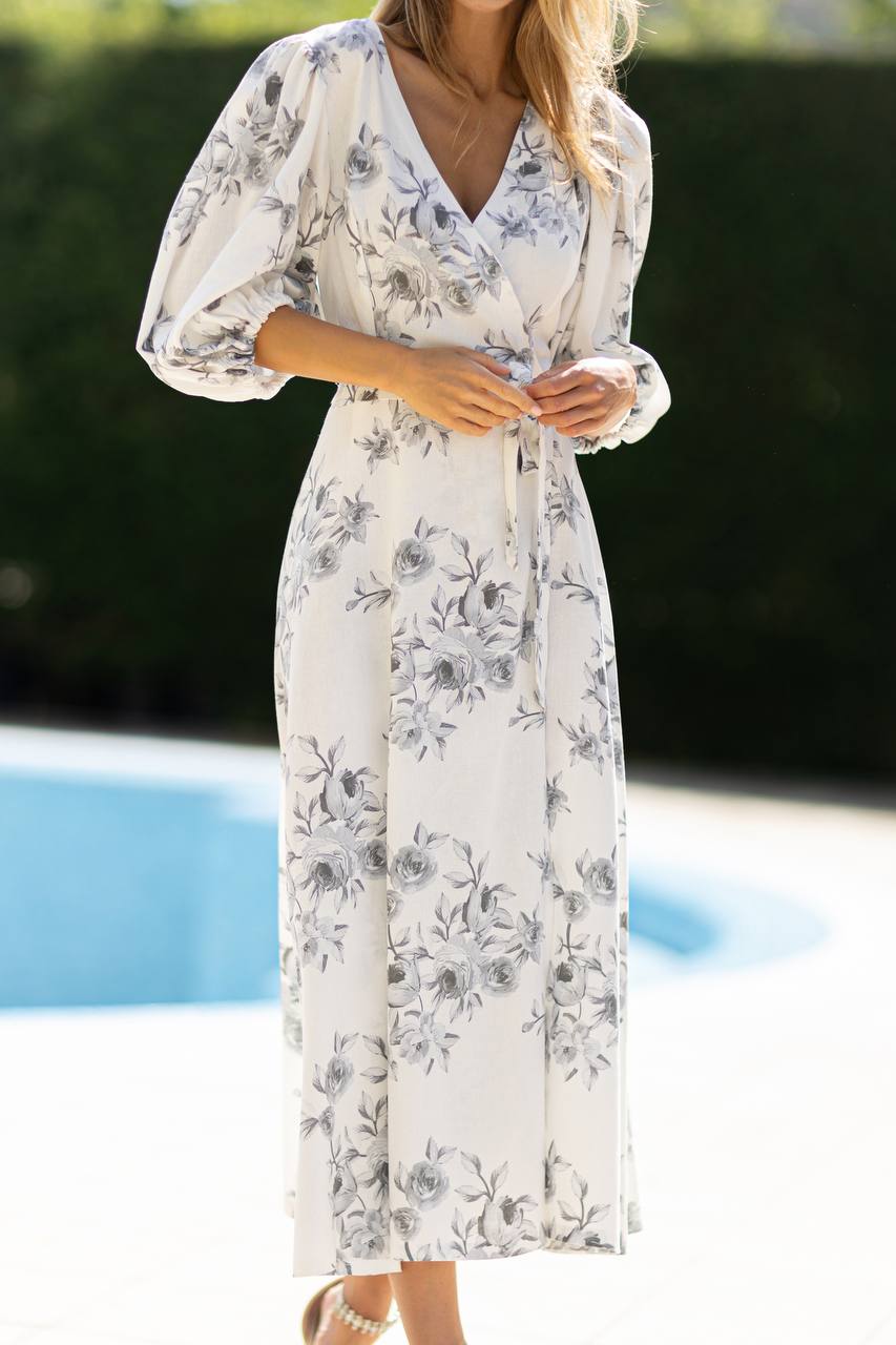 Woman wearing a floral dress by a poolside