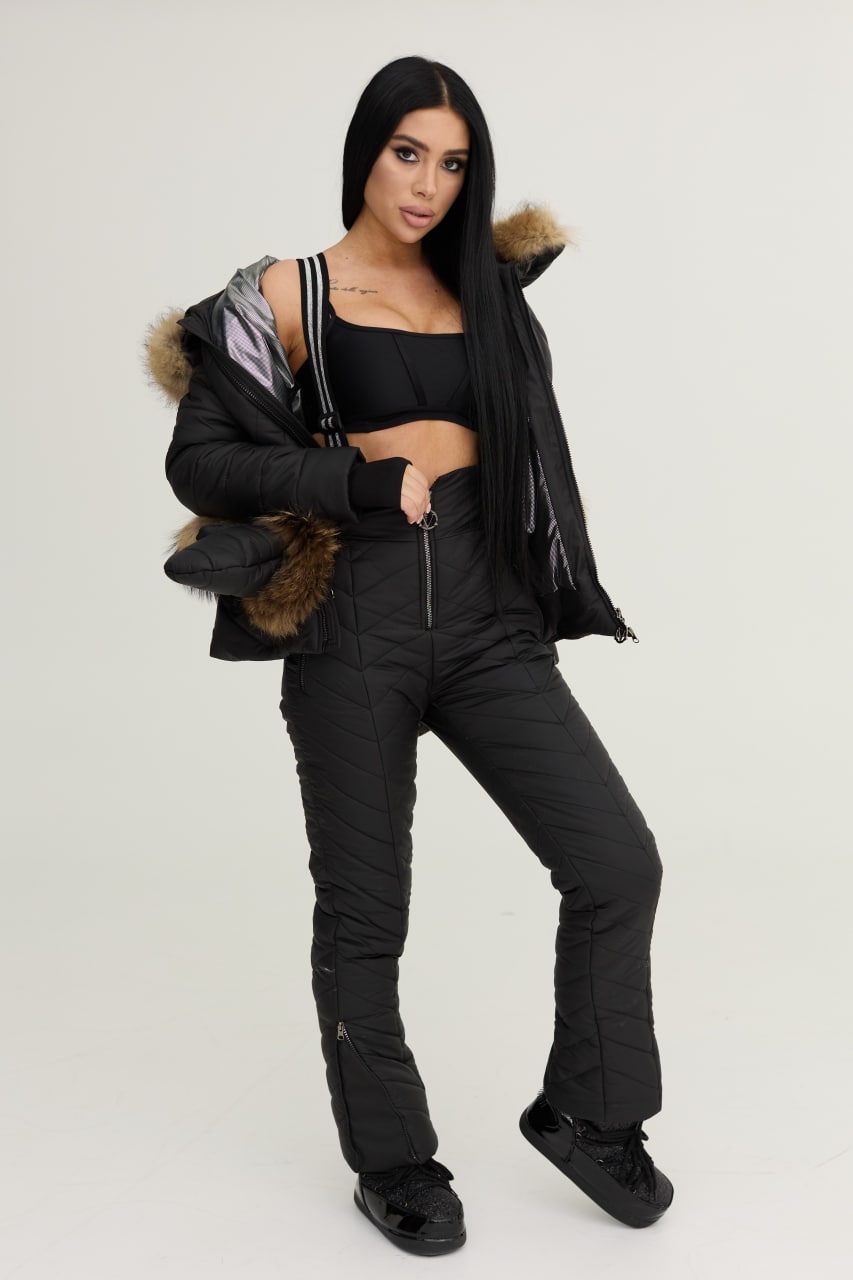 Woman wearing a black winter coat with fur trim on a white background