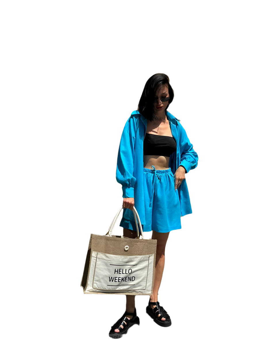 Woman in blue outfit holding a 'Hello Weekend' bag on a white background