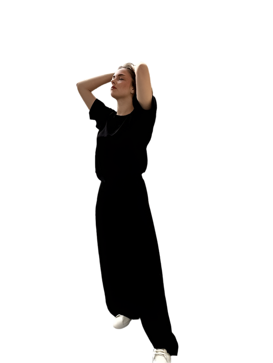 Person wearing a black dress on a white background