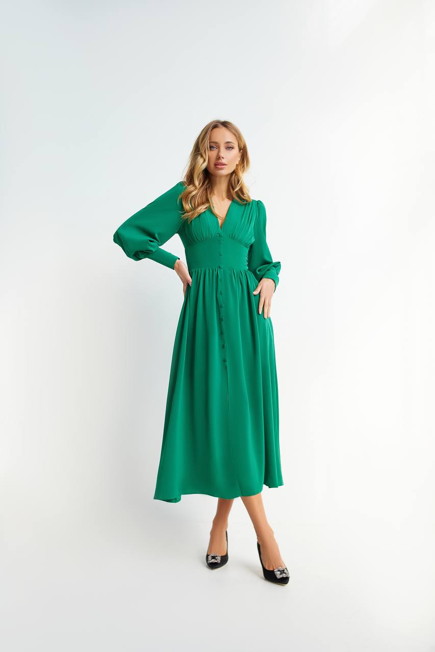 Woman wearing a green dress against a white background