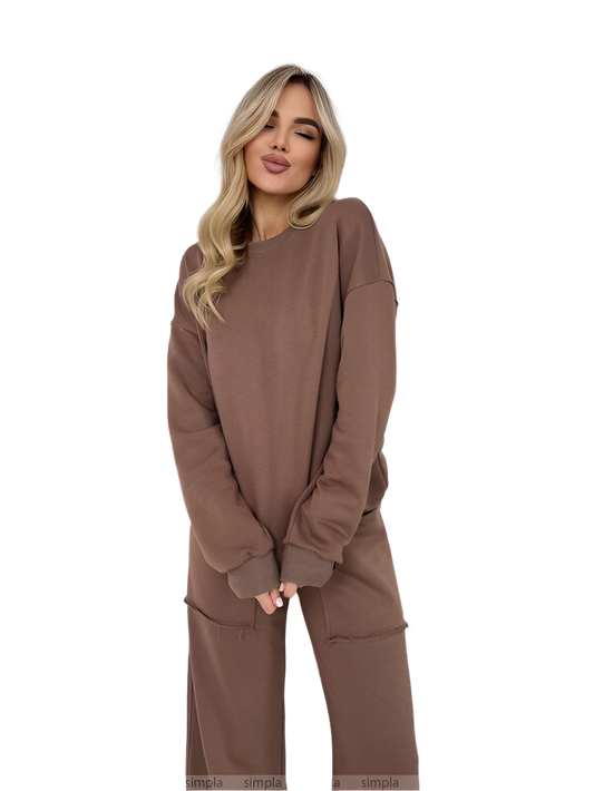 Woman wearing a brown sweatshirt and pants on a white background