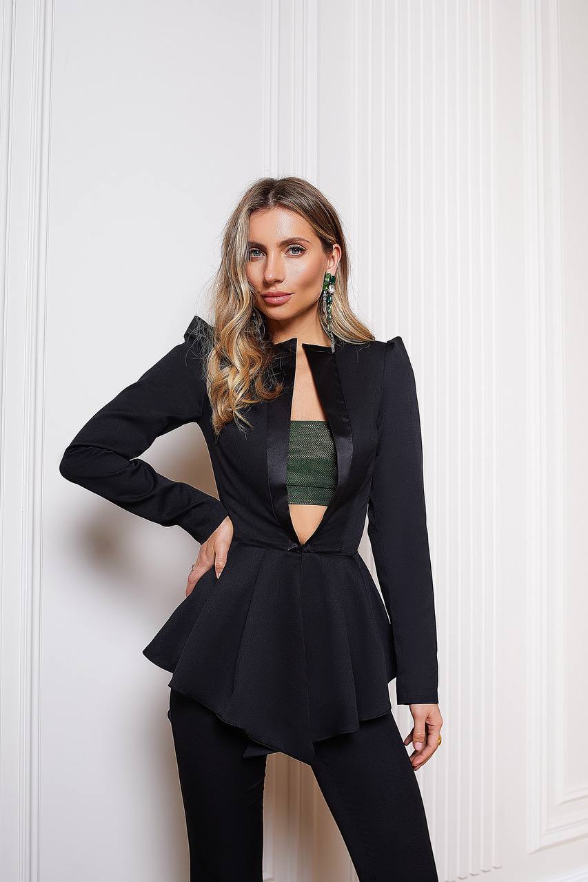 Woman wearing a black outfit with a white wall background