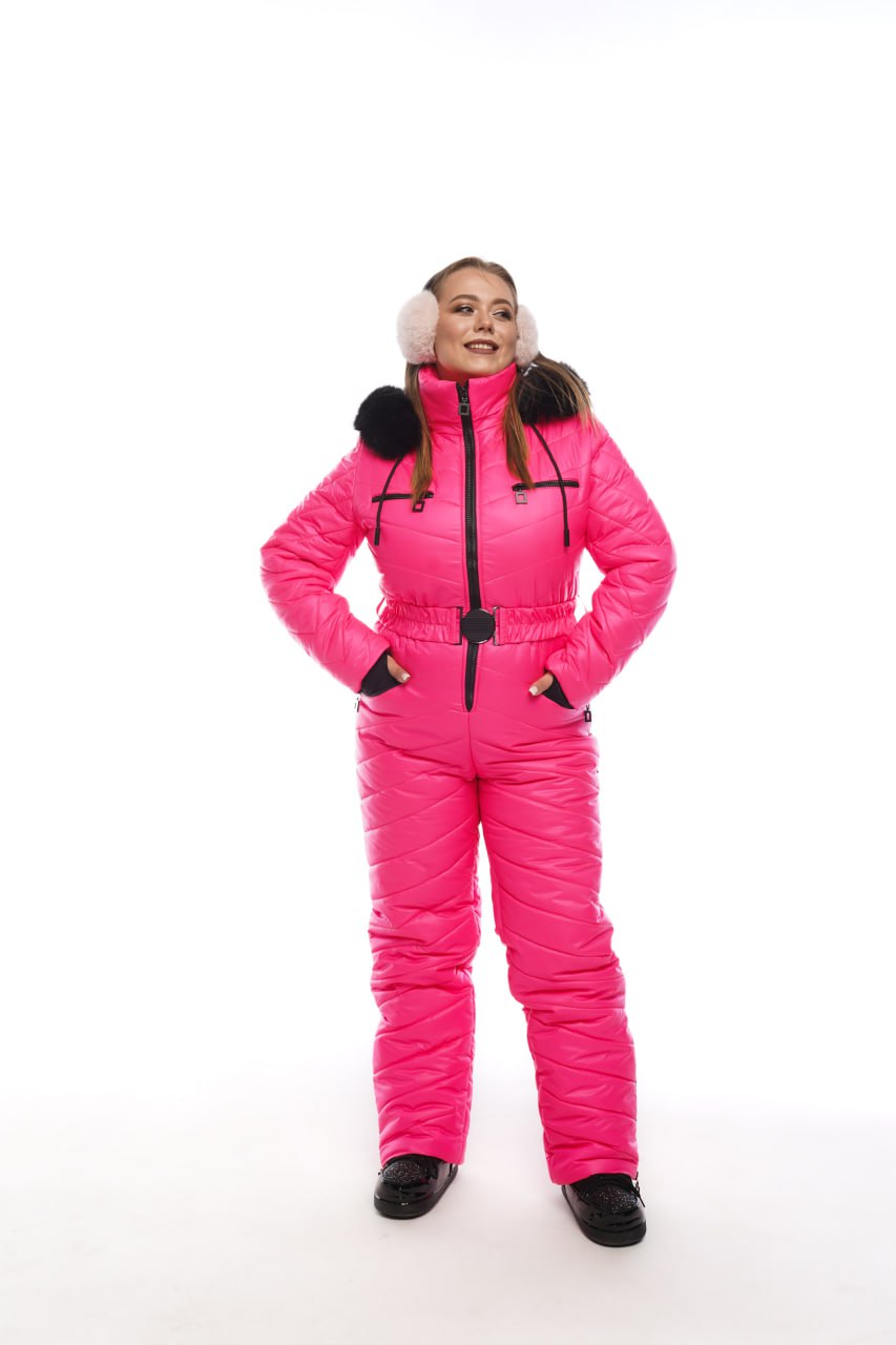 Person wearing a bright pink snowsuit on a white background