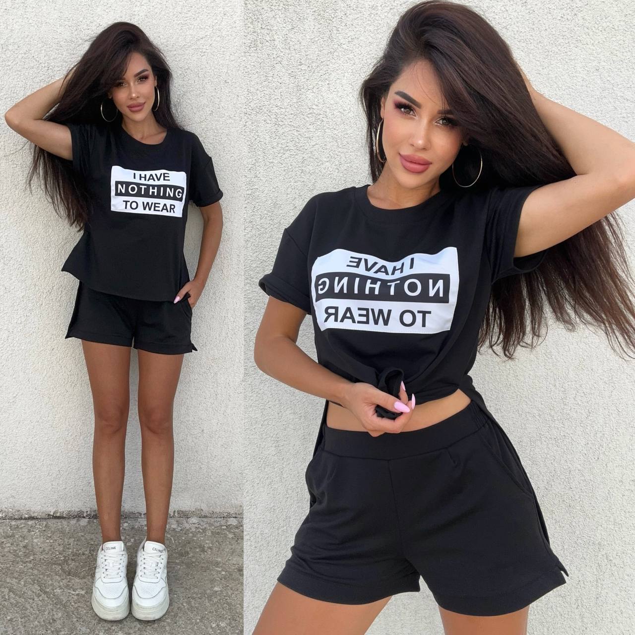Woman wearing a black t-shirt with text and black shorts against a light gray wall.