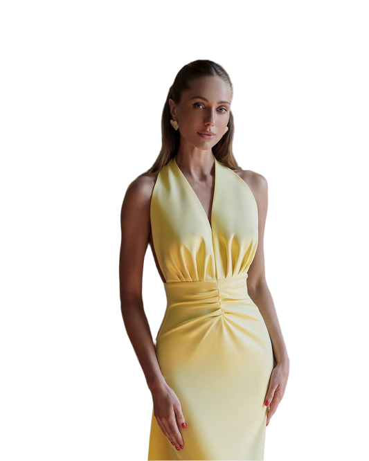 Woman wearing a yellow halter neck dress on a white background
