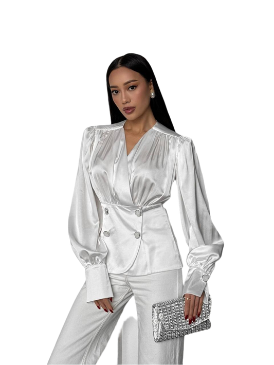Woman wearing a white satin outfit with a clutch on a white background