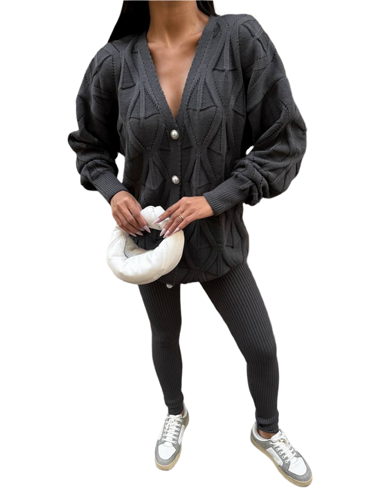 Person wearing a dark gray cardigan and leggings set on a white background