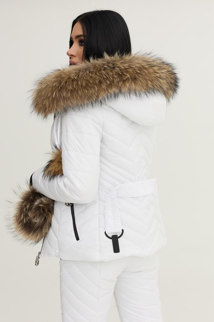 Person wearing a white puffer jacket with a fur-lined hood on a plain background