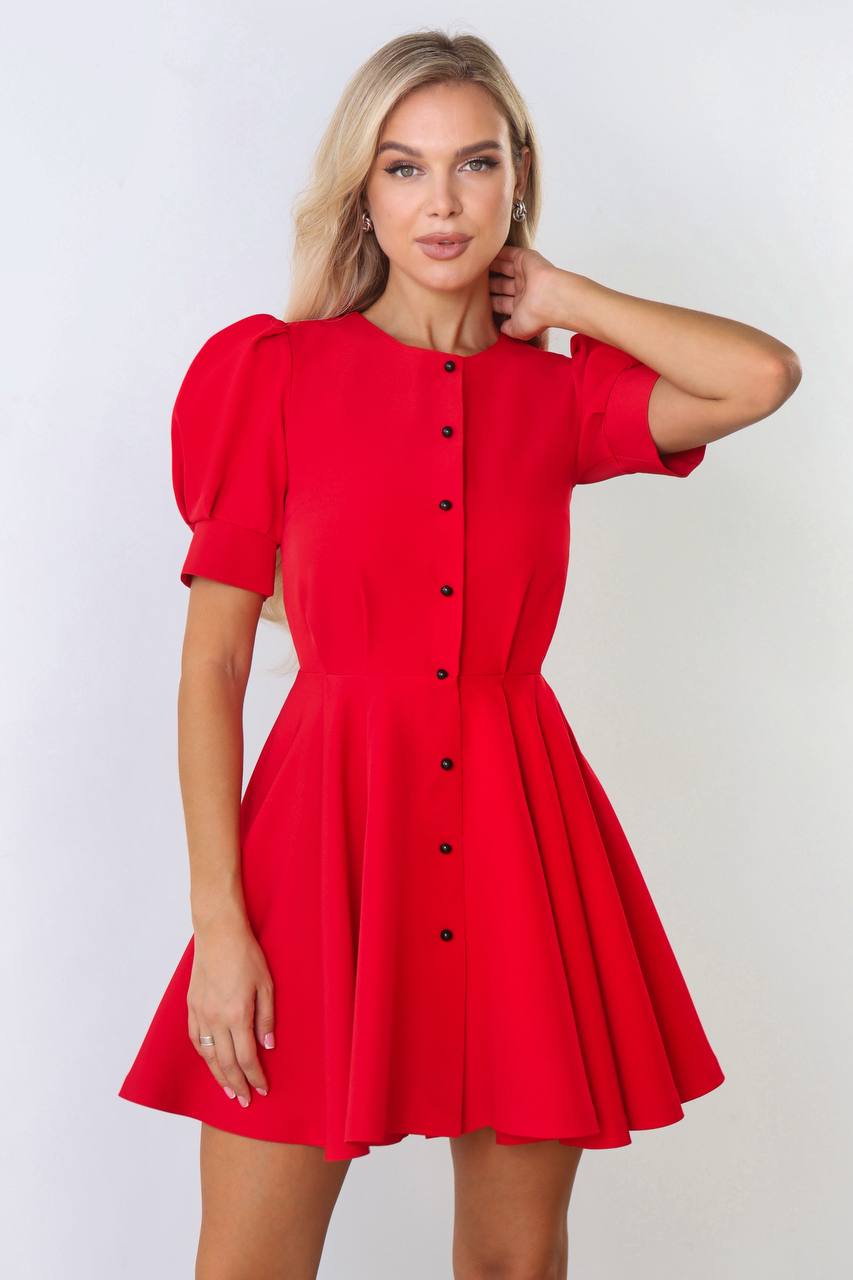 Woman wearing a red dress with puff sleeves on a white background