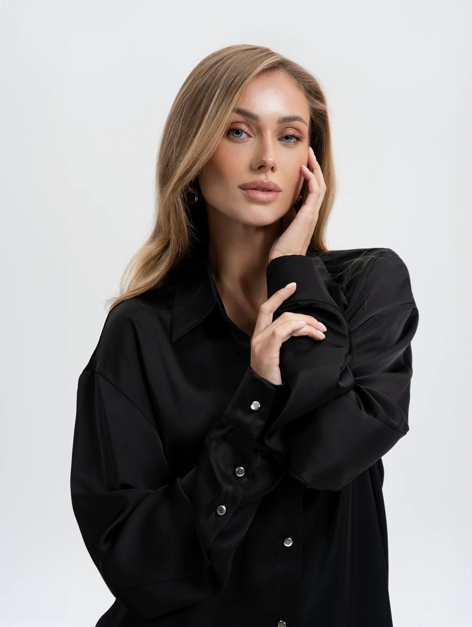 Woman wearing a black shirt against a white background