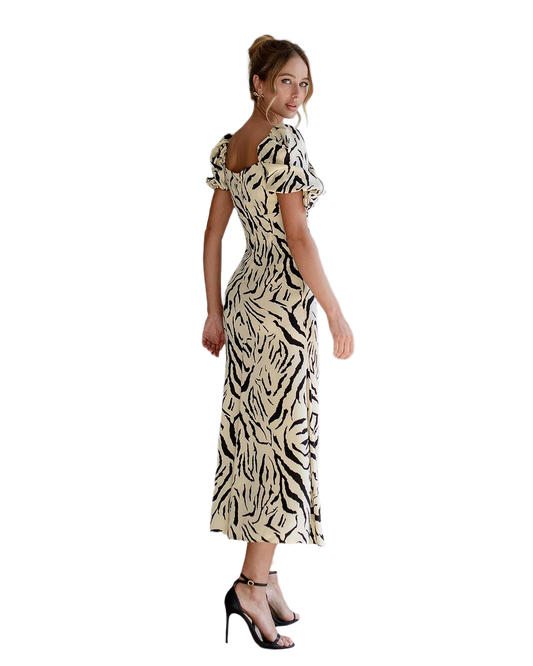 Woman wearing a zebra print dress on a white background