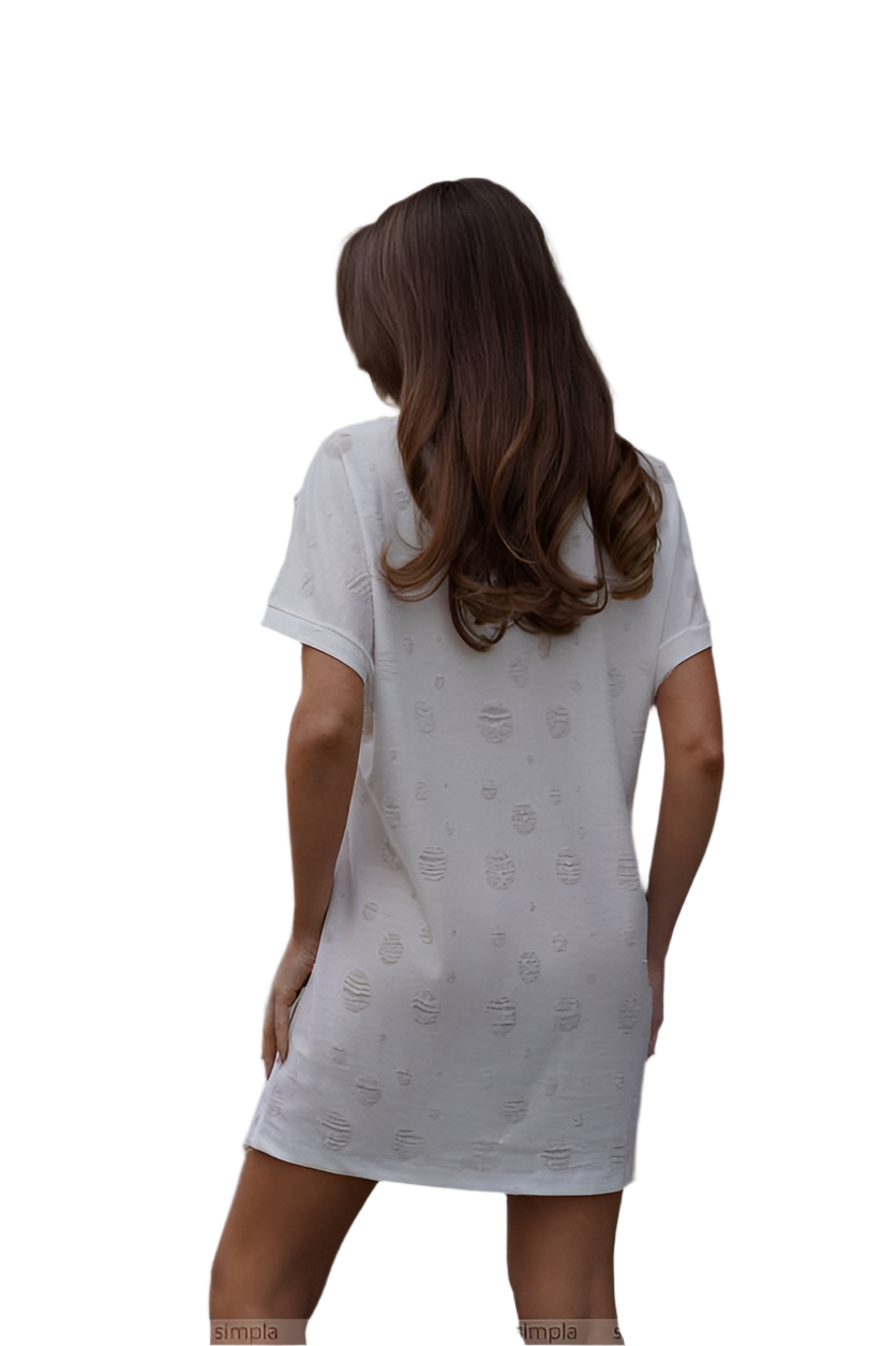 Woman wearing a white nightshirt with a subtle pattern on a white background