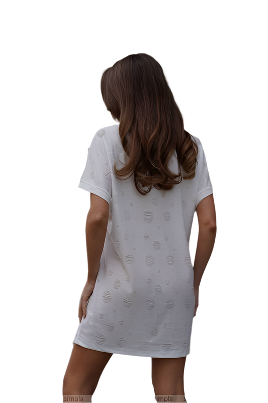 Woman wearing a white nightshirt with a subtle pattern on a white background