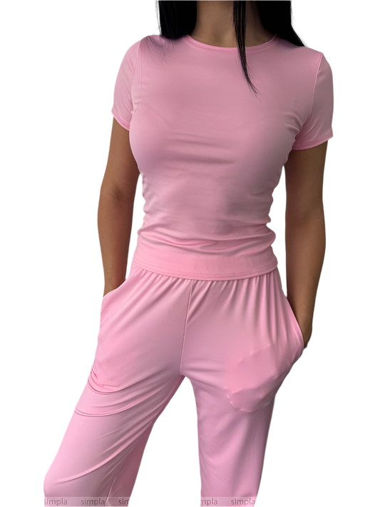 Person wearing a pink outfit on a white background