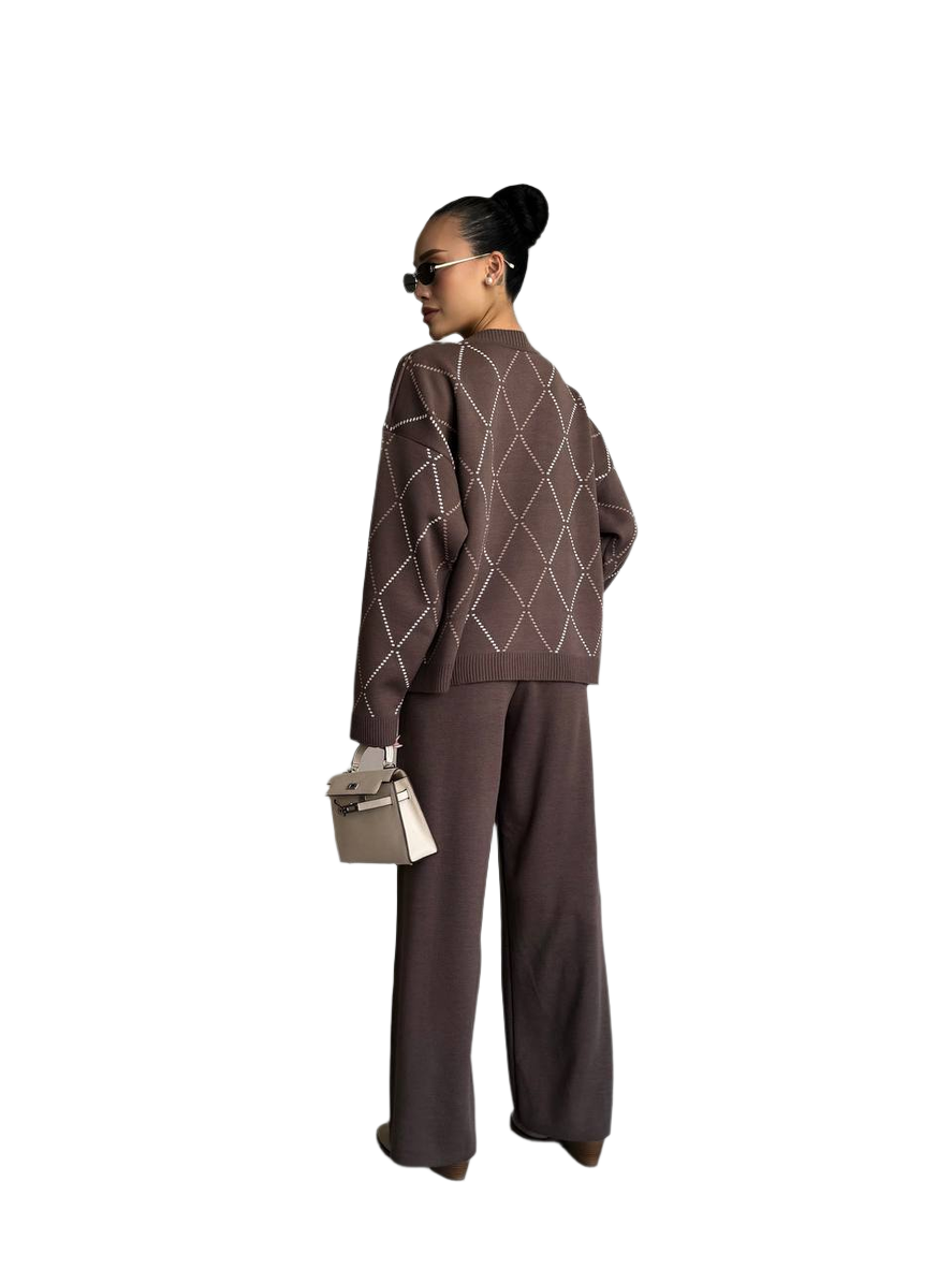 Person wearing a brown outfit with geometric patterns on a white background