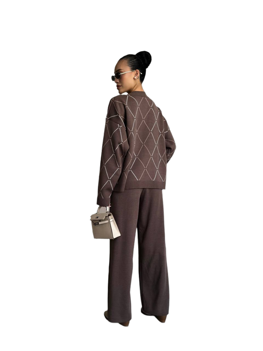 Person wearing a brown outfit with geometric patterns on a white background