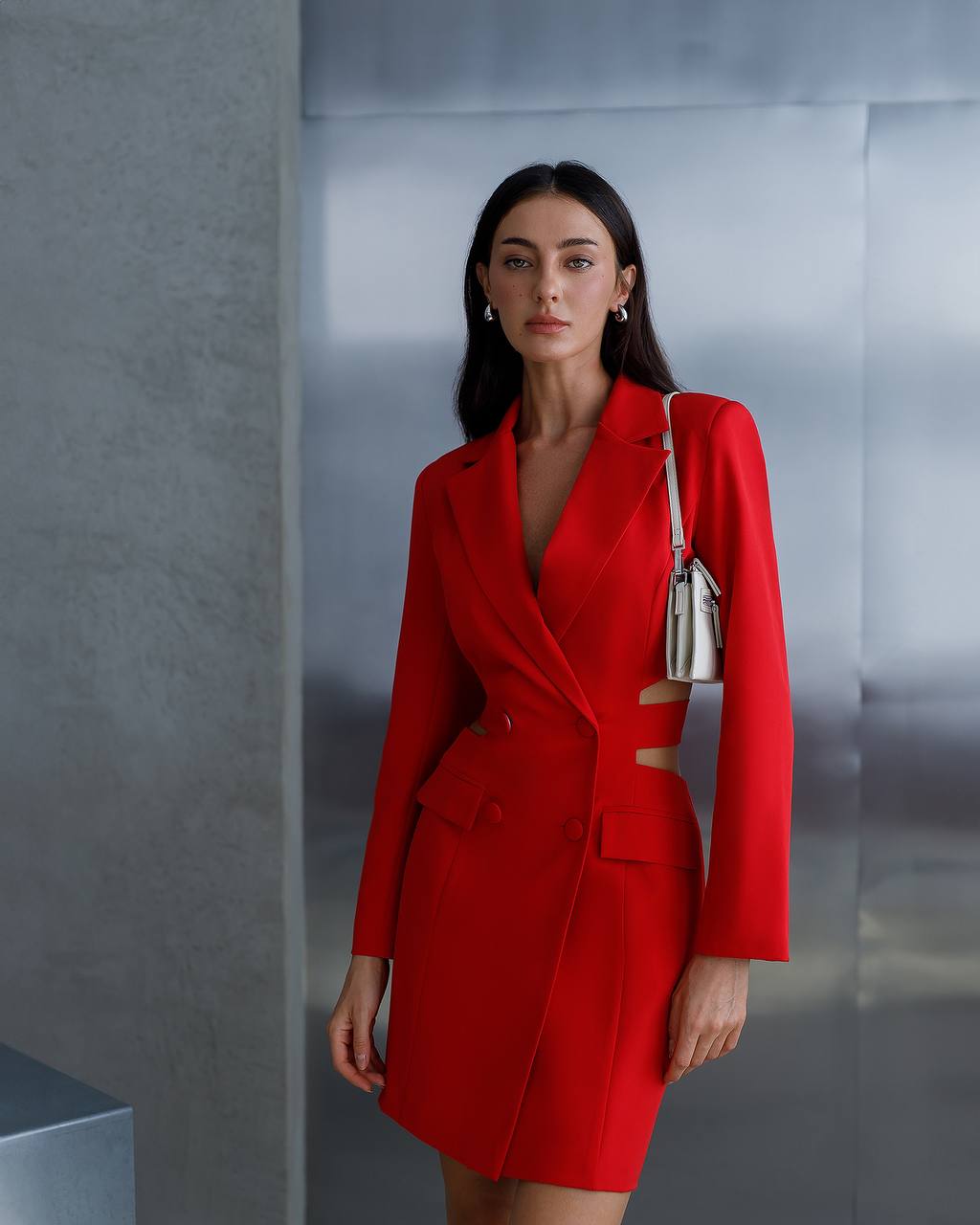Woman wearing a red blazer dress with a neutral background