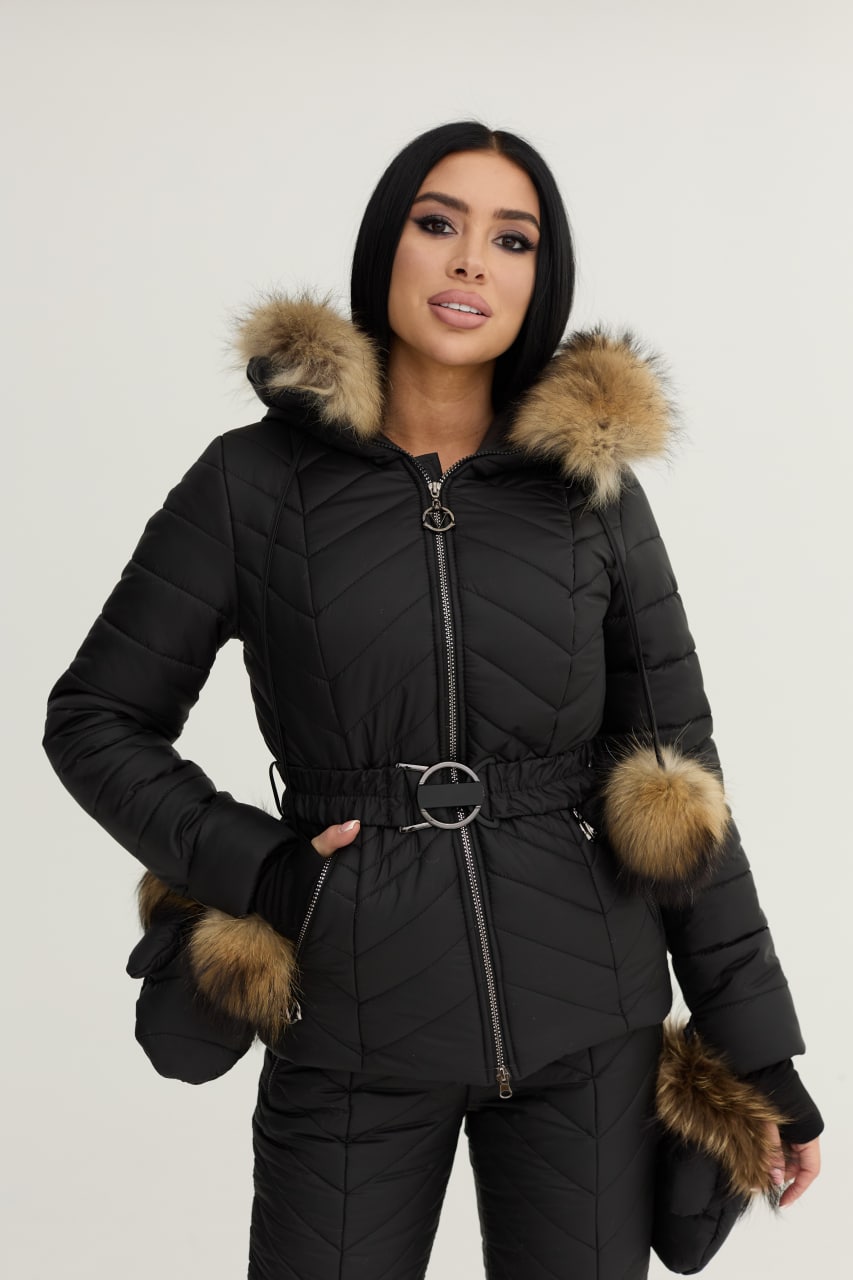 Woman wearing a black puffer jacket with fur trim on a white background