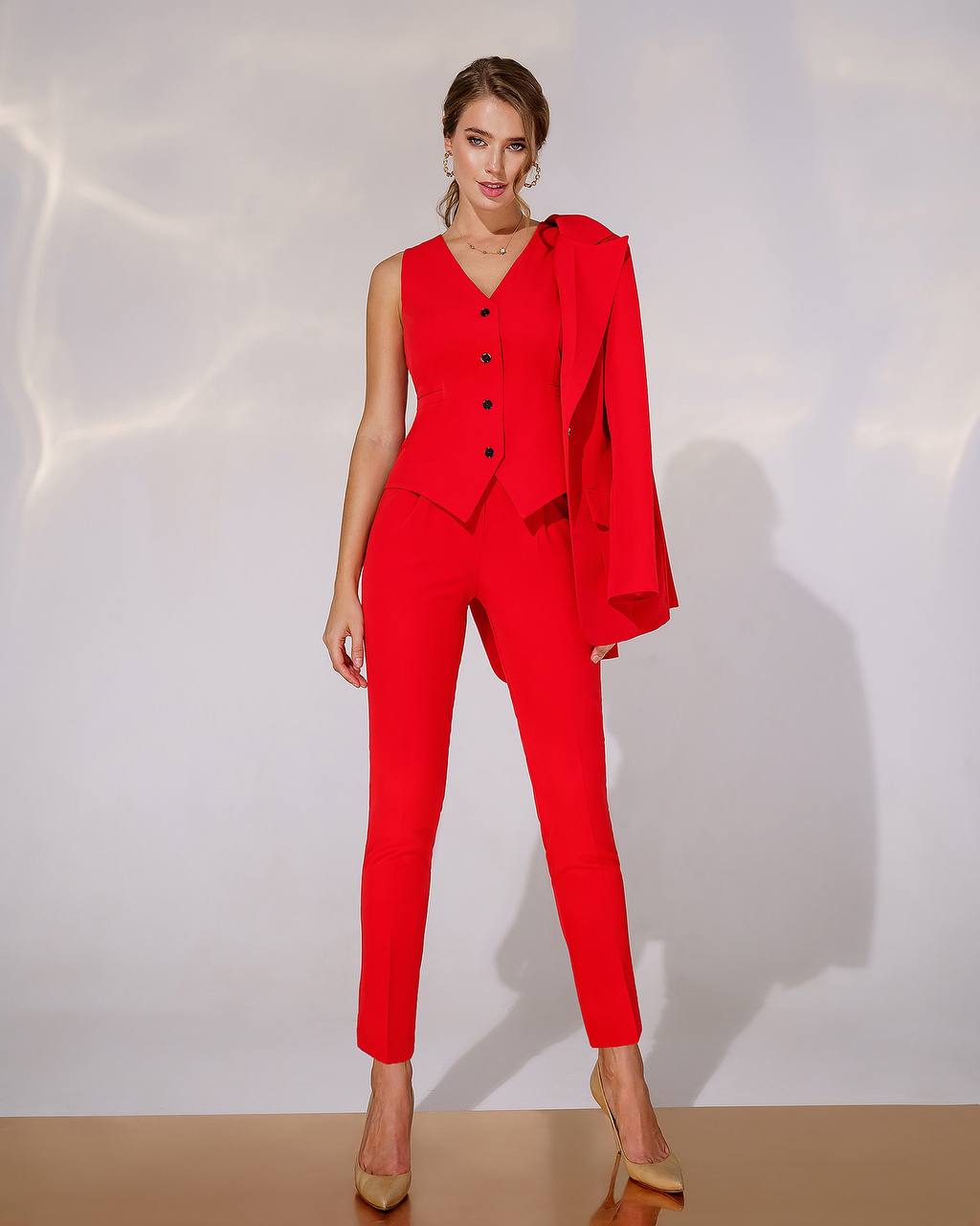 Woman wearing a red suit with a white background