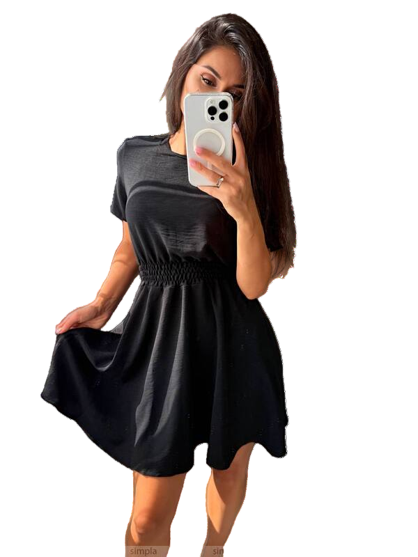Woman wearing a black dress holding a phone with a white background