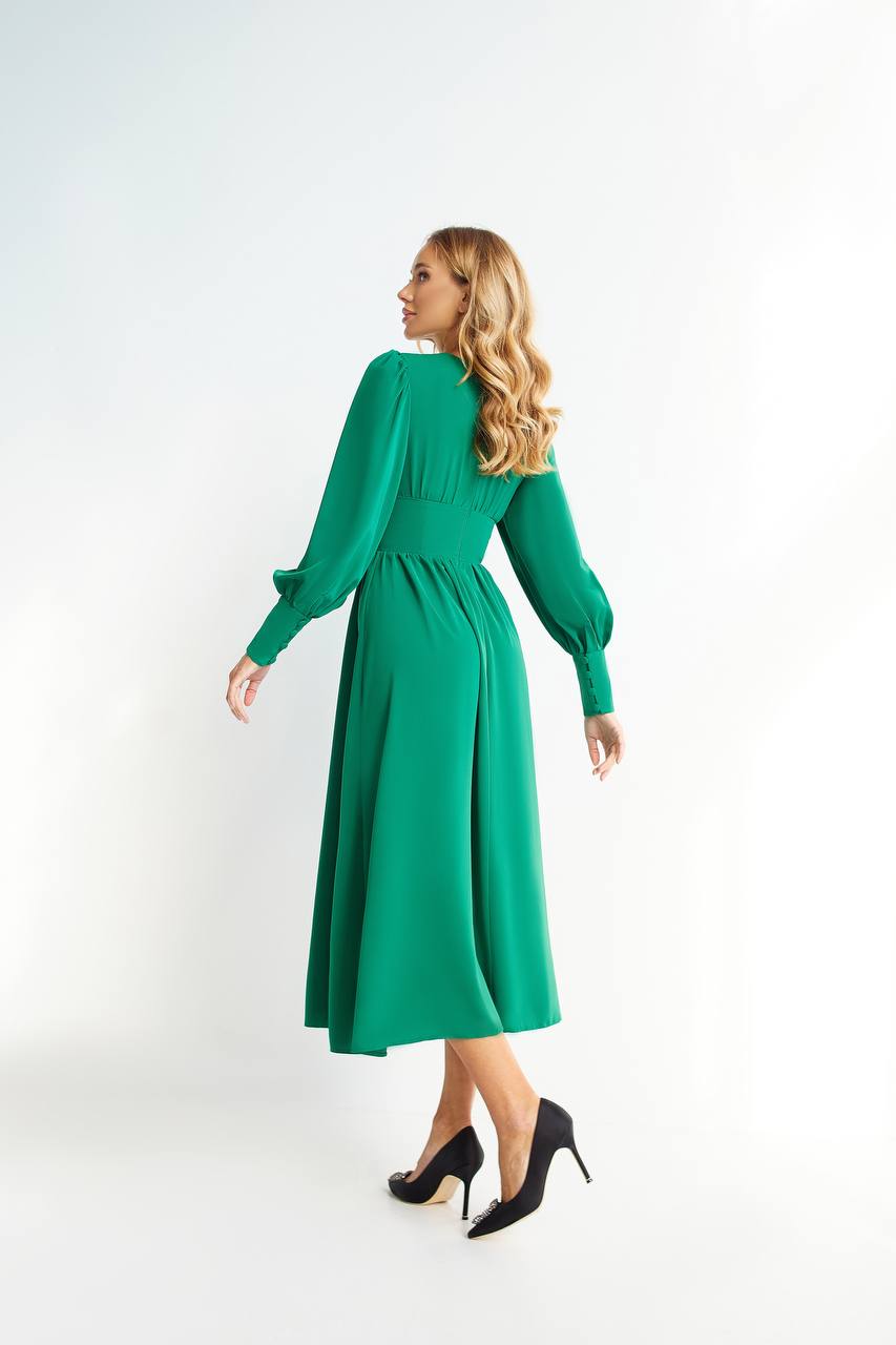 Woman wearing a green dress on a white background